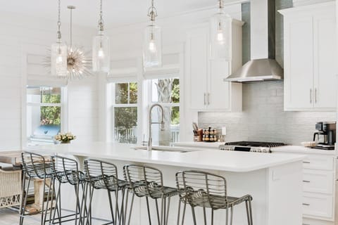 Beautiful kitchen featuring a large island, stainless steel appliances, ample seating, and fully stocked with all your essentials.