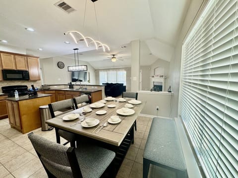 Gather around the dining table for family dinners or morning coffee, with open views to the living area.
