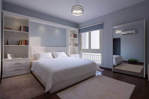 Wake up to soft natural light in this serene and spacious master bedroom, complete with built-in shelving, plush bedding, and a full-length mirror for added comfort and style.