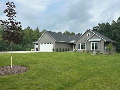 This new, beautiful home on 2.5 acres features a fenced yard and pond.