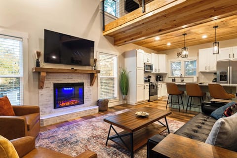 Cozy Living Room — vaulted ceilings, electric fireplace, and smart TV for movie nights.