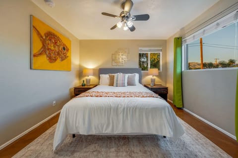 Bright and comfortable Bedroom 2 with queen bed, ceiling fan, and stylish, cozy décor