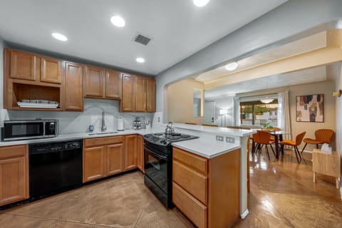 Well-equipped kitchen opens to the home`s dining area with table that comfortably seats five