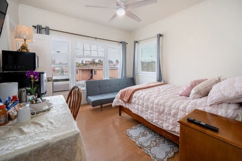 Private studio in a two-story apartment building with 15 units, offering a private entrance, dual security doors (wood + metal screen), 24/7 self check-in via lockbox, full-size bed plus a 6` futon (convertible to a second bed), private bathroom, work des