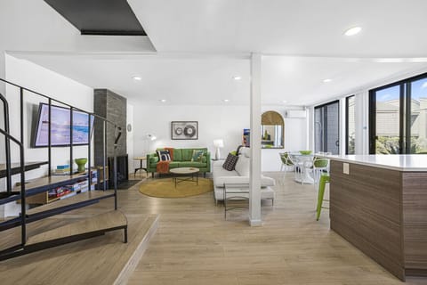 Living Area with fireplace, open kitchen and dining