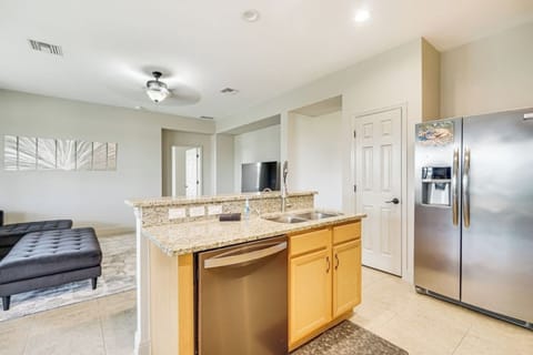 A spacious kitchen island with a sink and dishwasher makes meal prep and cleanup a breeze.