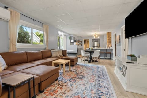 Relax in the spacious living room with a comfy couch and smart TV, the perfect spot to unwind after a day of adventures.