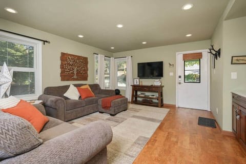 Spacious living room includes high end couches and a large SMART TV.  