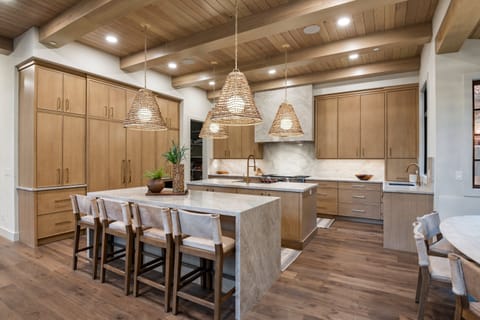 A huge chef's kitchen is well stocked with premium appliances and supplies, two kitchen islands, a built in dining area with beautiful alpine views.