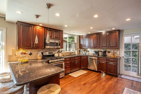 A bright, fully stocked kitchen with bar seating for four and everything you need to cook, gather, and enjoy time together.