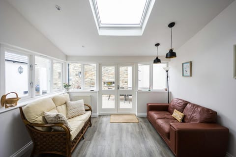 Conservatory with two large sofas and standard lamp