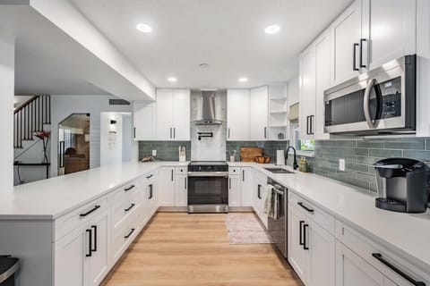 kitchen, fully stocked with appliances including coffee pot and keurig