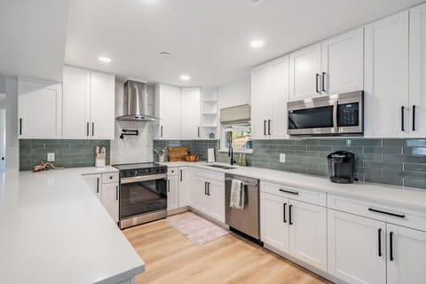 kitchen, fully stocked with appliances including coffee pot and keurig