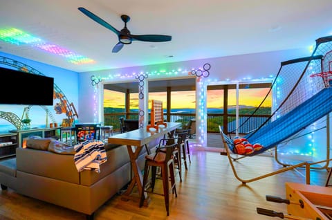 SILVER DOLLAR LODGE by Great Escapes homes includes a fun Time Traveler themed game/living space complete with amazing Table Rock Lake views, games, basketball, foosball, arcade, and more.