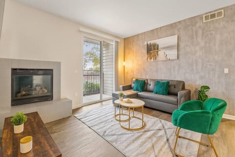 Bright modern living room with fireplace and cozy seating. Perfect for relaxing and unwinding.