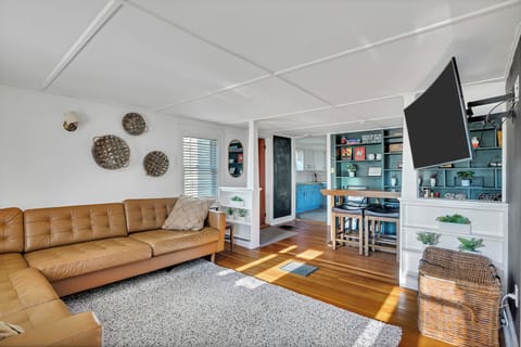 Large open living room with lots of natural sunlight and large TV