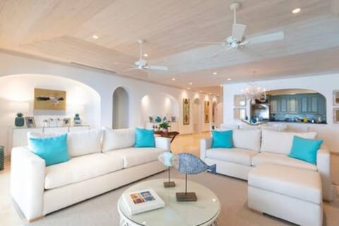 Stunning open plan living area with comfortable sofas, TV, Air conditioning, ceiling fans and wonderful sea views via the verandah area. 