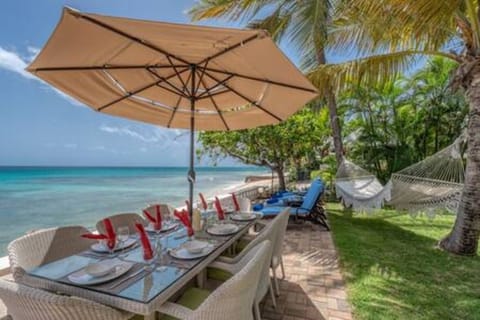 The terrace area with seating for 8 guests, along with sun loungers and a hammock.
