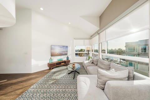 Modern, sun-drenched living area featuring stunning waterfront scenery