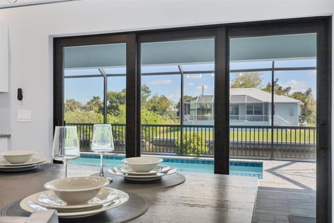 Dining area overlooing sparkling pool