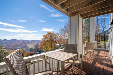 Covered deck with seating and long-range mountain views.