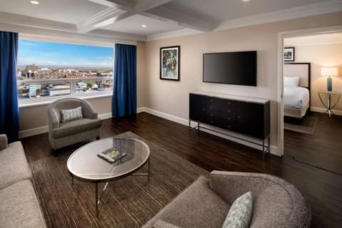 Living room with TV, chairs, and city view
