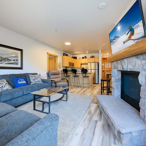 Living room with gas fireplace and large TV