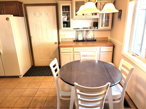 DINING AREA: The home has a circular dining table with seating for up to 4 adults