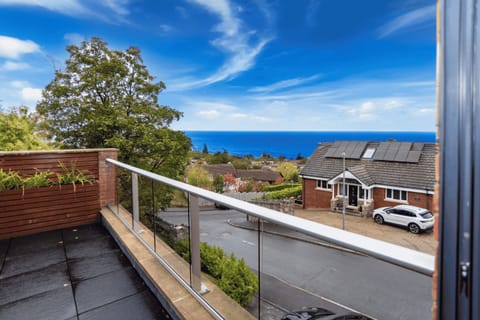 Generous balcony with comfortable seating, sea views, and a seamless indoor-outdoor living flow.