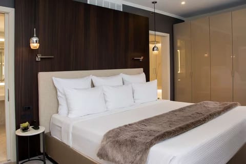 Sink into crisp linens beneath warm, boutique-style lighting.
