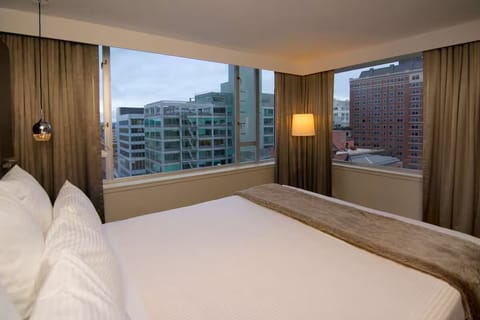 Wake up to sweeping city views from a cloud-soft bed.