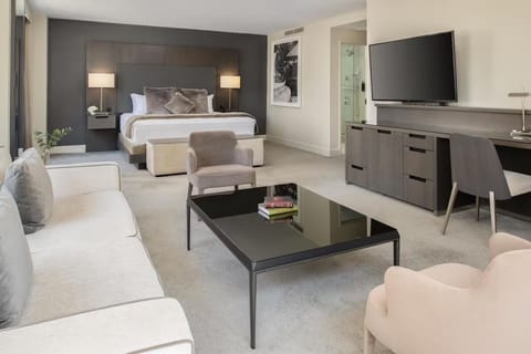Stretch out in an airy suite with lounge seating and TV.