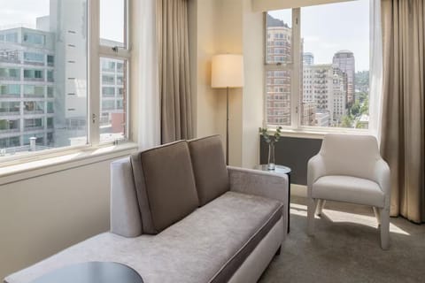 Sip coffee beside corner windows with skyline views.