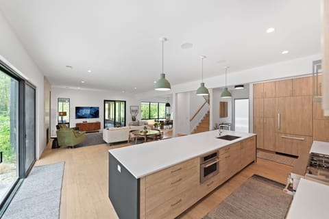 Chef’s kitchen with 14-ft island, custom cabinetry, and high end appliances