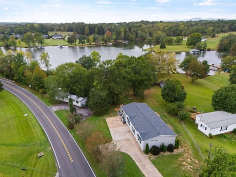 Our home in relation to the lake. Our property borders the lake with mature trees, a picnic table, and private dock for guests to enjoy. 