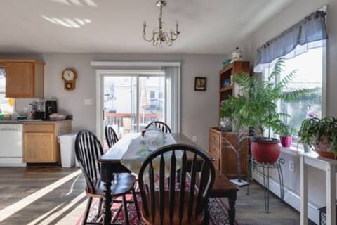 Dine in natural light pouring in through large windows. Fitted with a spacious rustic wooden table and chairs, this is the perfect setting for your meals.