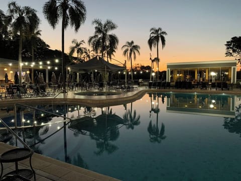 Unwind at sunset as palms glow over mirror-calm waters.