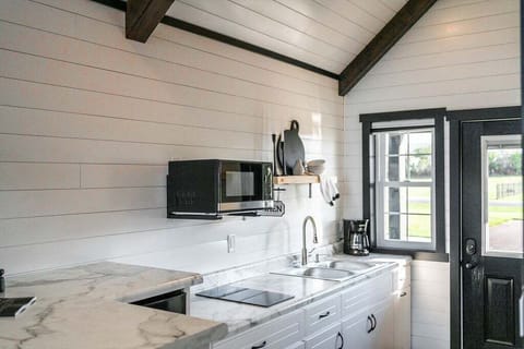 The kitchenette is equipped with a microwave, mini refrigerator, drip coffee maker, and hot plate.