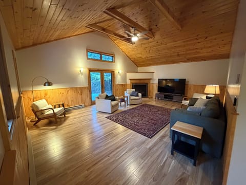 Huge living room with access to deck & a propane fireplace.