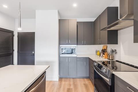 Sleek kitchen design with ample storage and built-in appliances.