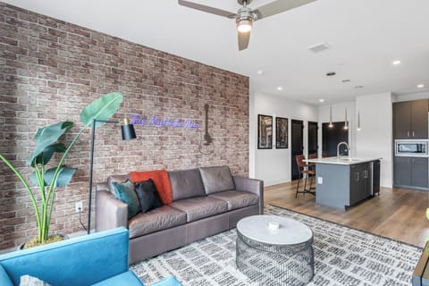 Open-concept living and dining area with large windows and natural light.