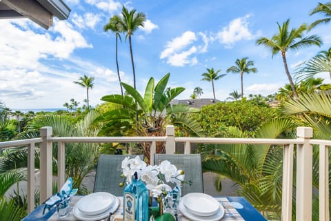 Start your day on a private balcony with a cozy dining setup and lush tropical views—perfect for morning coffee or sunset dining