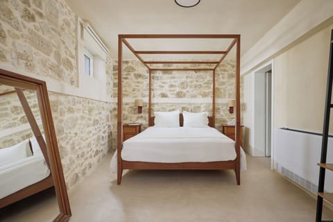 romantic master with a four-poster bed & stunning stone walls, a serene retreat