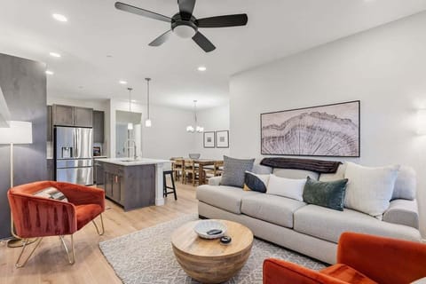 Unwind in your stylish open-plan living space with plush seating and vibrant pops of color.