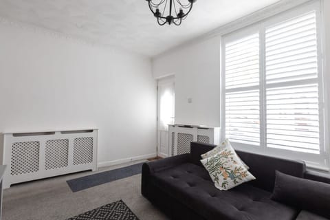 Living room with large L-shaped sofa and bay window
