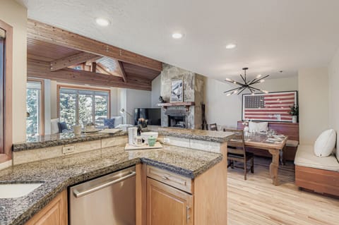 Cook in a gourmet rustic kitchen! Featuring stunning granite countertops, high-end stainless steel appliances, custom knotty-wood cabinetry, and unique bear-themed bar stools.