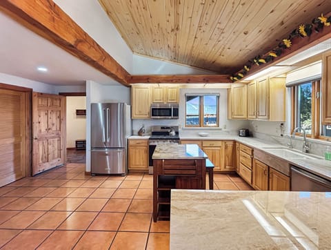 Your spacious kitchen welcomes you with warm wood beams and natural light streaming through windows. You'll love preparing meals with modern stainless steel appliances and plenty of counter space for all your culinary adventures.