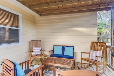 A cozy outdoor porch retreat is perfect for relaxing with friends, showcasing comfortable seating and a tranquil ambiance.