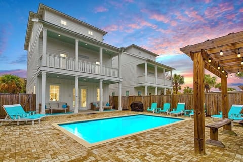 Watercolor—your perfect group getaway that SLEEPS 24! Just steps from the beach, this stunning retreat includes a FREE golf cart. Unwind in the backyard oasis with a HEATED pool, outdoor kitchen, and lounge seating. Plus a game room!