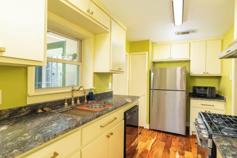Bright, fully equipped kitchen w/ stainless steel appliances & warm wood floors